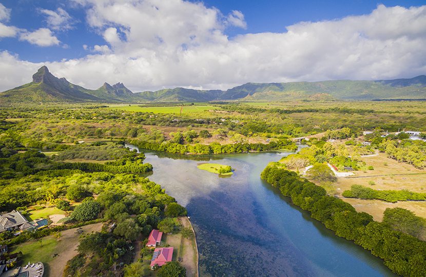 Top down aerial view of Black River Tamarin - Mauritius beach. Curepipe Black River Gorge National Park in background by Quality Master